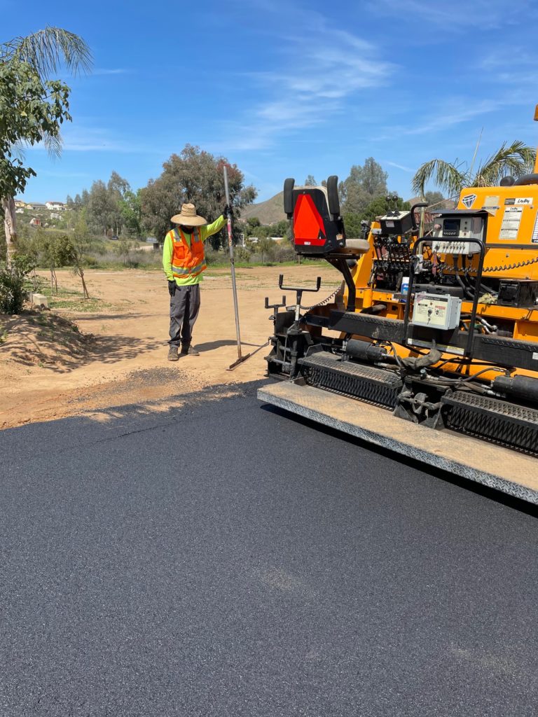 Black Diamond Asphalt performing grading and paving services in Perris CA, leveling asphalt for smooth and durable surfaces